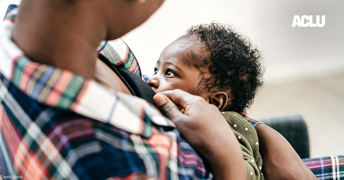 A Black person chest-feeding an infant